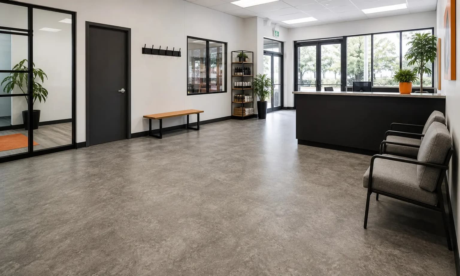 Grey commercial resilient flooring installed through an open office and reception area